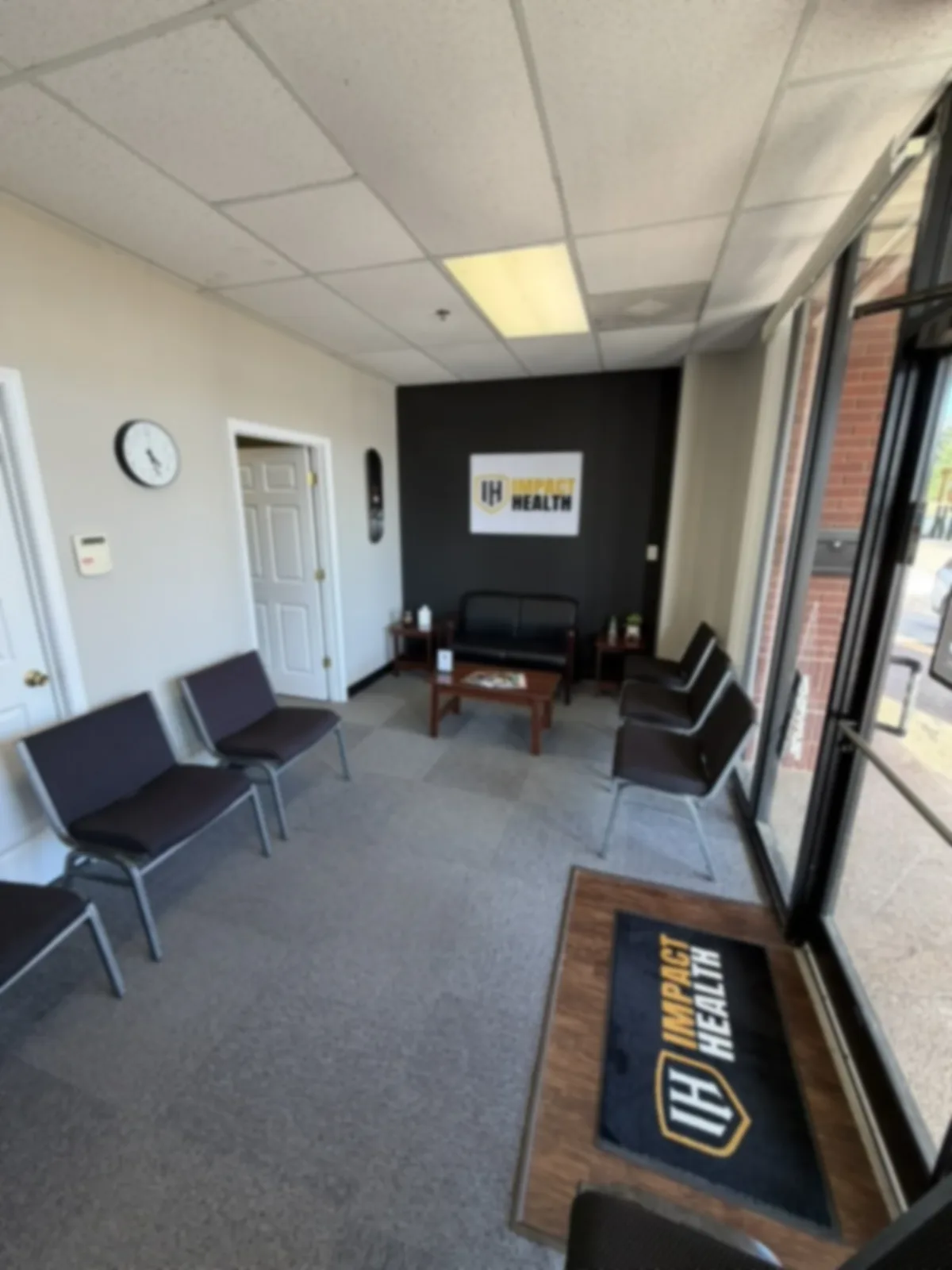 Impact Health Olive Branch lobby, branded sign and entry mat with natural daylight