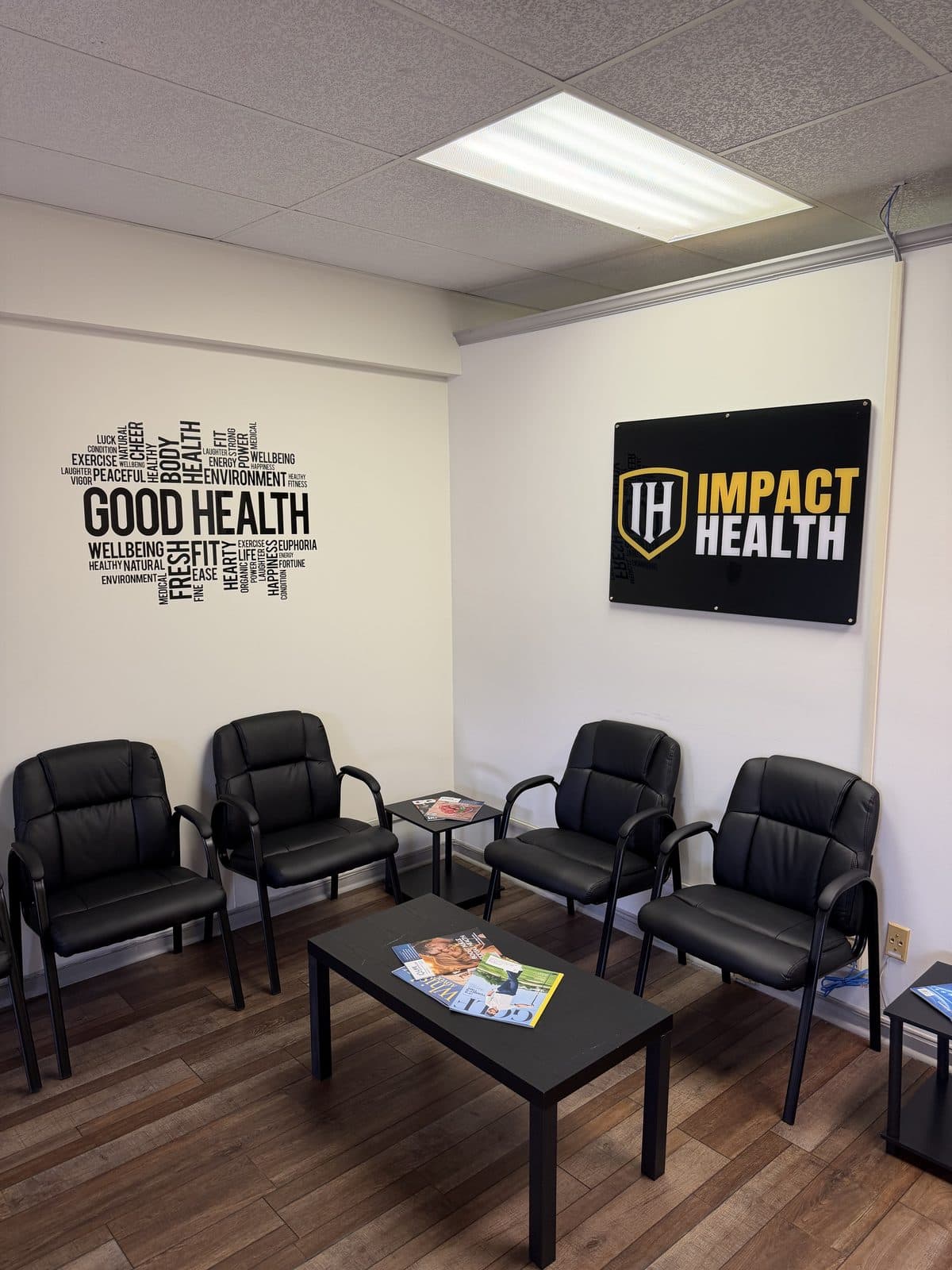 Impact Health Tupelo lobby with waiting chairs, Good Health wall art, and Impact Health sign